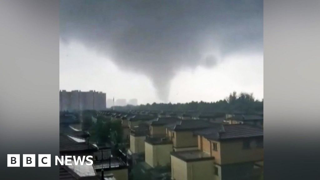 Debris flies through air as tornado hits China city